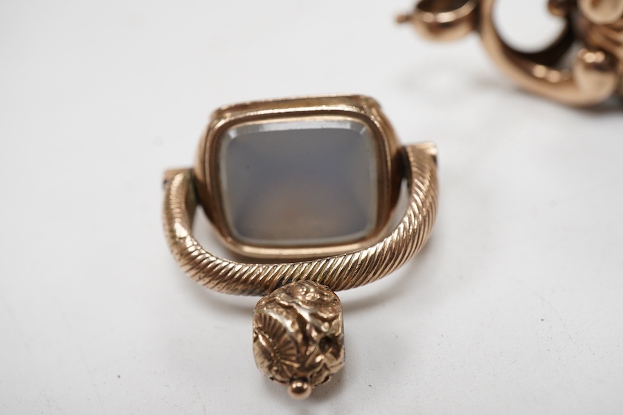 Three assorted 19th century yellow metal over laid fob seals, to include spinning set with three chalcedony stones, oval with white chalcedony carved with initials and rectangular with carnelian varved with a crest, larg